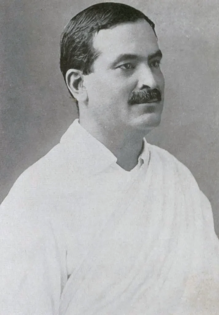 Dr. Bidhan Chandra Roy, seated in formal attire, likely as Mayor of Calcutta, with a composed expression and a backdrop of a formal setting.