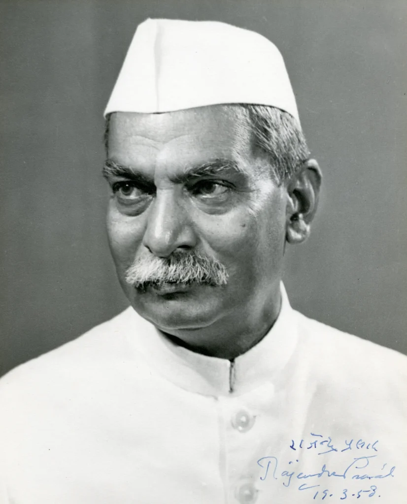 Dr. Rajendra Prasad wearing a white Nehru jacket and Gandhi cap.