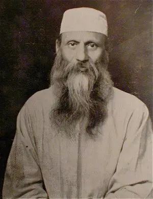 Dr. Bhagwan Das wearing traditional Indian attire, with round glasses and a long beard, looking to the side.