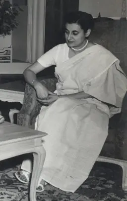 Indira Gandhi in 1956, wearing a saree and looking to the side with a calm expression.