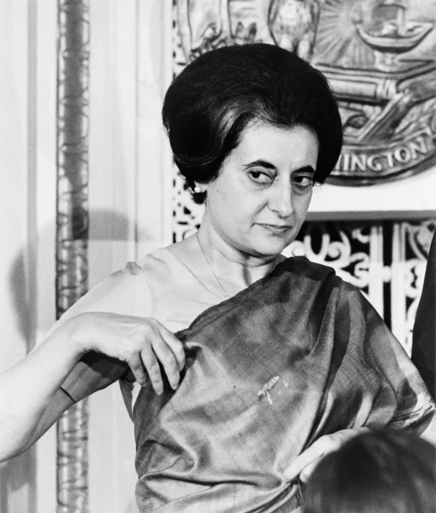 Official portrait of Indira Gandhi, former Prime Minister of India, wearing a traditional saree with a composed expression.
