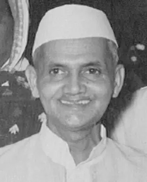 portrait of Lal Bahadur Shastri, India’s second Prime Minister, wearing a white Nehru jacket and traditional Gandhi cap, with smiling expression.
