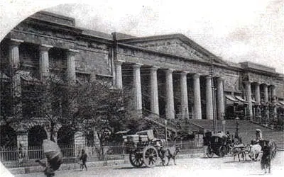 the building’s symmetrical triangular pediment and white stone exterior evoke classical Greek and Roman architecture.