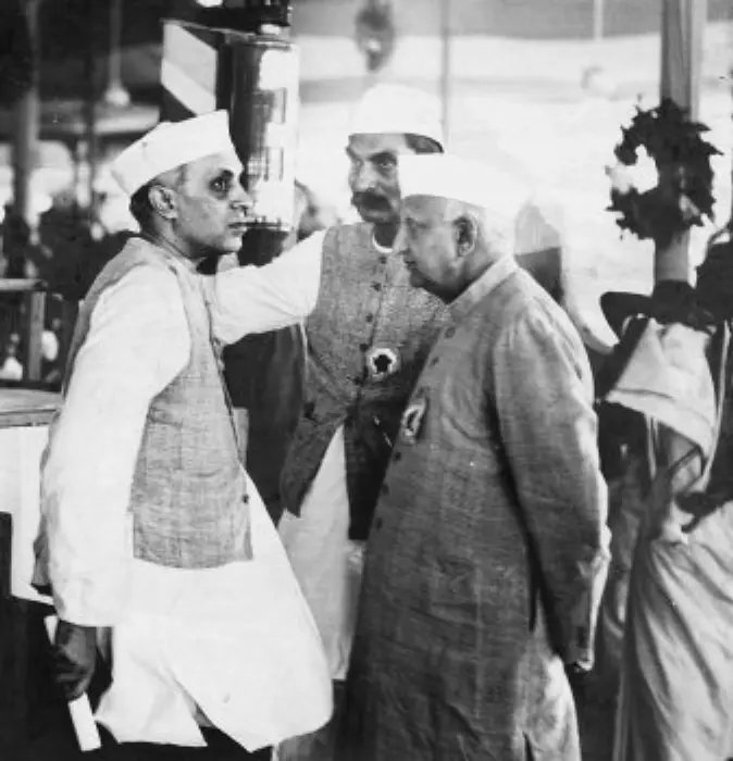 Historic photograph of Jawaharlal Nehru, Bhulabhai Desai, and Rajendra Prasad seated together during an Indian National Congress session.