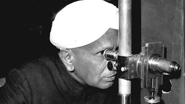 C. V. Raman looking through a scientific instrument while conducting research in physics.