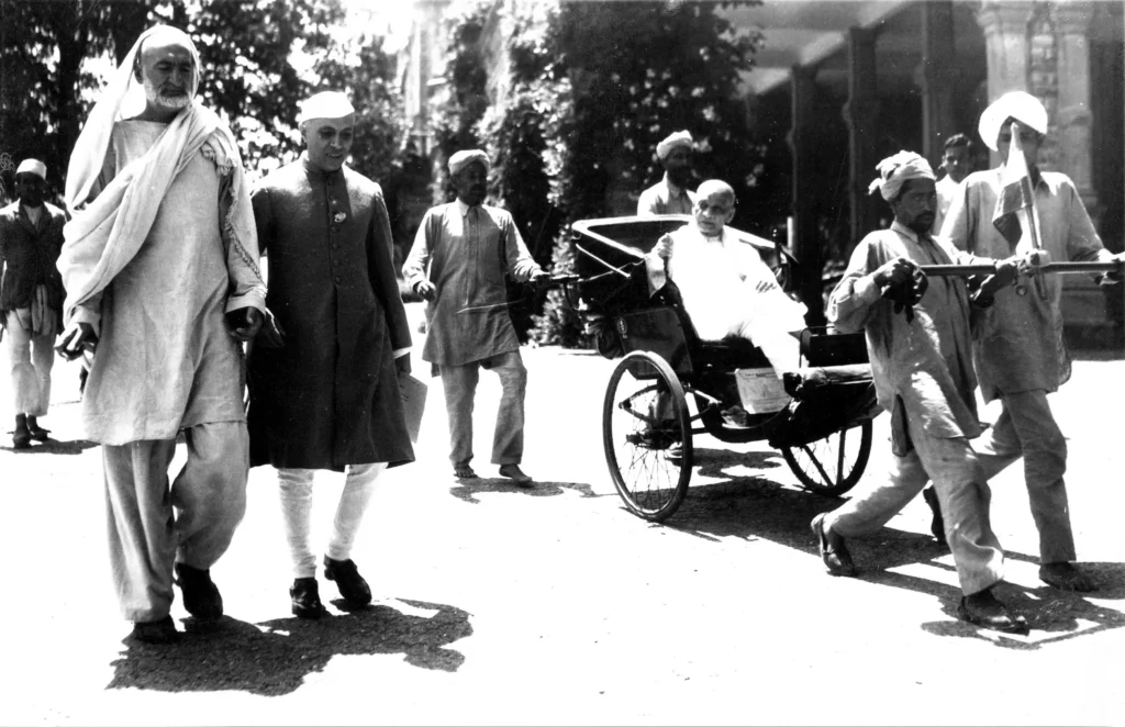 Abdul Ghaffar Khan, Jawaharlal Nehru, and Sardar Vallabhbhai Patel standing together in 1946, all dressed in traditional Indian attire.