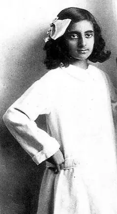 portrait of a young Indira Gandhi wearing a simple dress, looking slightly to the side.