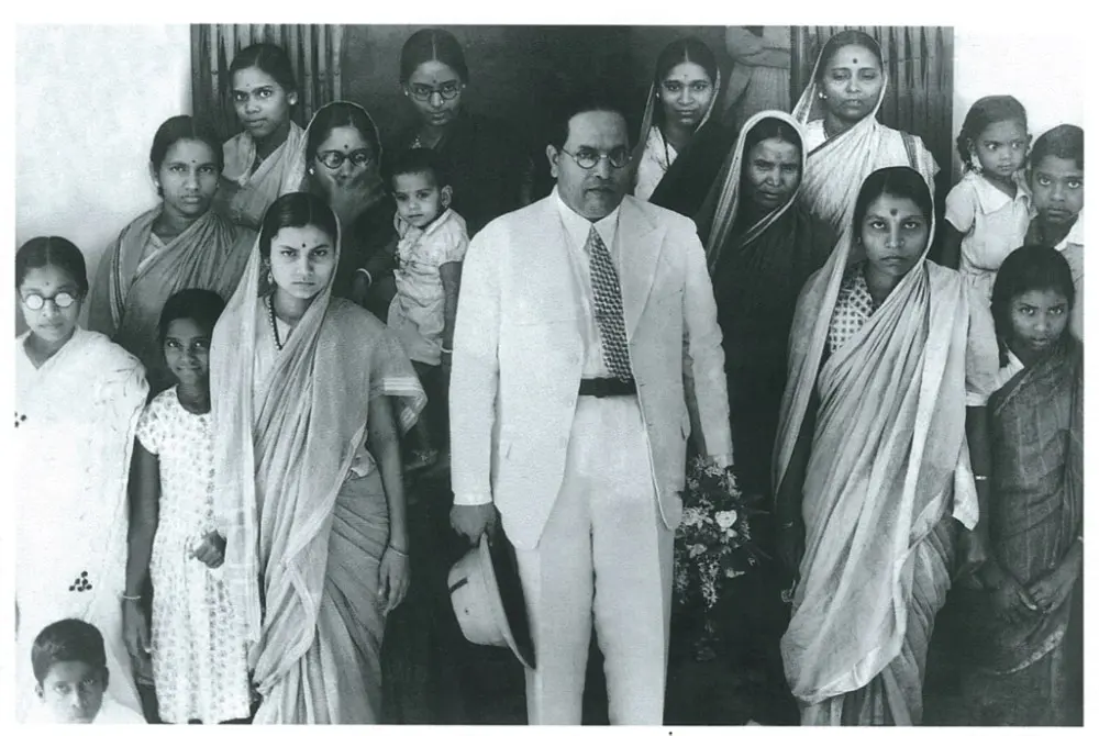 Dr. B. R. Ambedkar standing with a group of women delegates of the Scheduled Caste Federation during a conference in Nagpur.