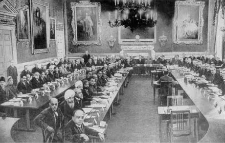 Dr. B. R. Ambedkar is seated in the front row, third from the left, among other delegates discussing constitutional reforms for India.