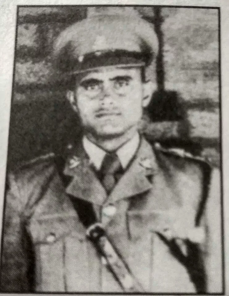 Portrait of a uniformed Indian Army soldier standing outdoors, holding a sword and shield.